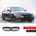 Load image into Gallery viewer, Front Quarter angle shot of a black BMW 3 Series G20 parked on a concrete road with a white backdrop, fitted with an ENKAHNZ centre grille; product grille shown at the bottom of the image.