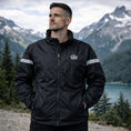 Load image into Gallery viewer, Enkahnz Trademark Crown Jacket – Black in a nature background front view.