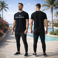 Load image into Gallery viewer, Enkahnz Trademark Crown T-Shirt – Black on a white man in a resort setting.