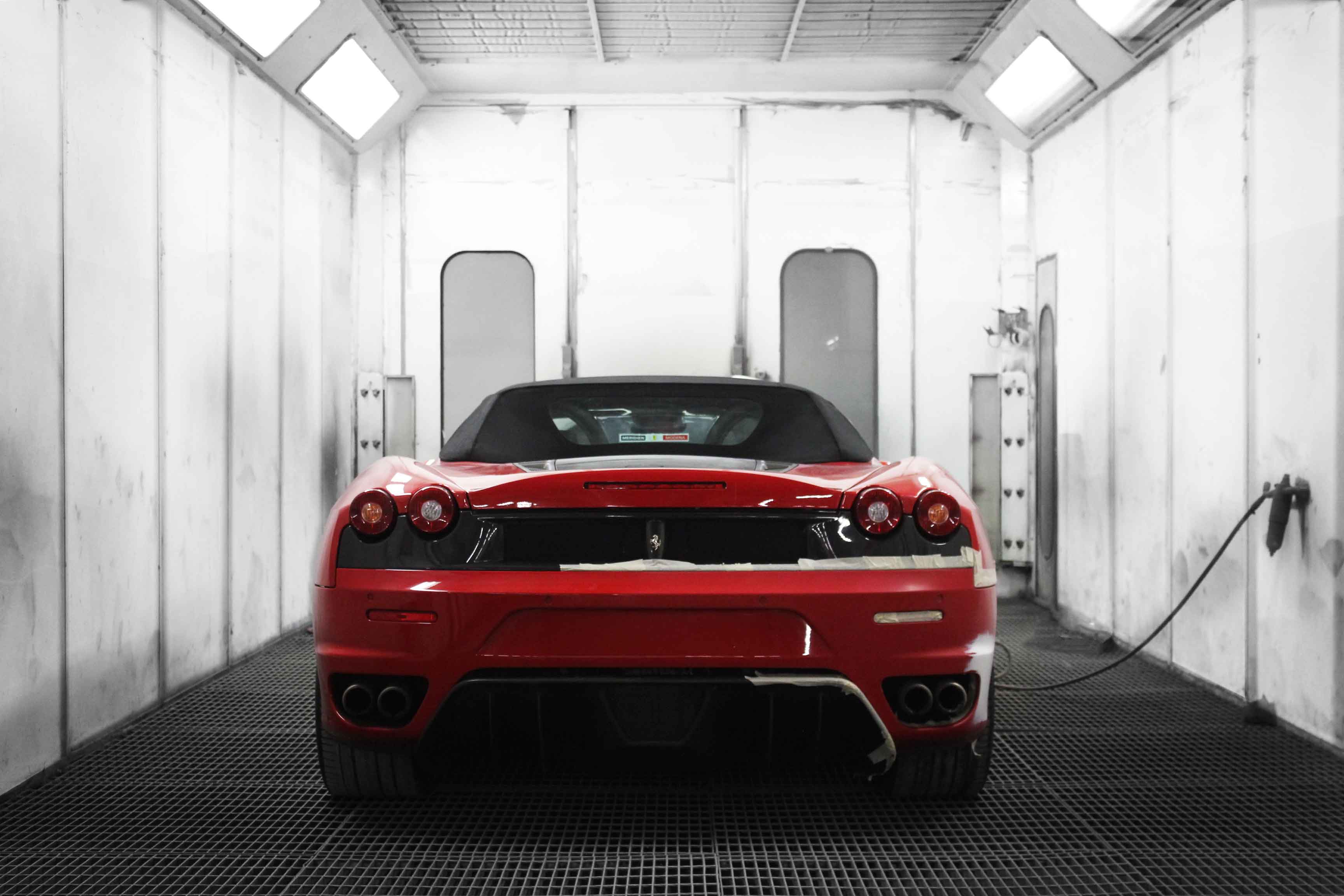 Red Ferrari 360 Modena inside the Enkahnz spray booth