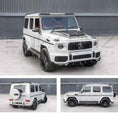 Load image into Gallery viewer, White Mercedes-Benz G-Class SUV shown from front, side, and rear angles parked outside in front of Enkahnz HQ.