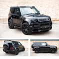 Load image into Gallery viewer, Black Land Rover Defender 90 L663, fitted with Barugzai Falcon bodykit, parked on a road with a brick wall background. Fitted with Barugzai Sabre 22" alloy wheels in Gloss Black