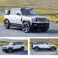 Load image into Gallery viewer, Silver Land Rover Defender 110 L663 SUV, fitted with Barugzai Falcon bodykit on a road with grassy fields in the background. Fitted with Barugzai Sabre 22" alloy wheels in Gloss Black Polished Face