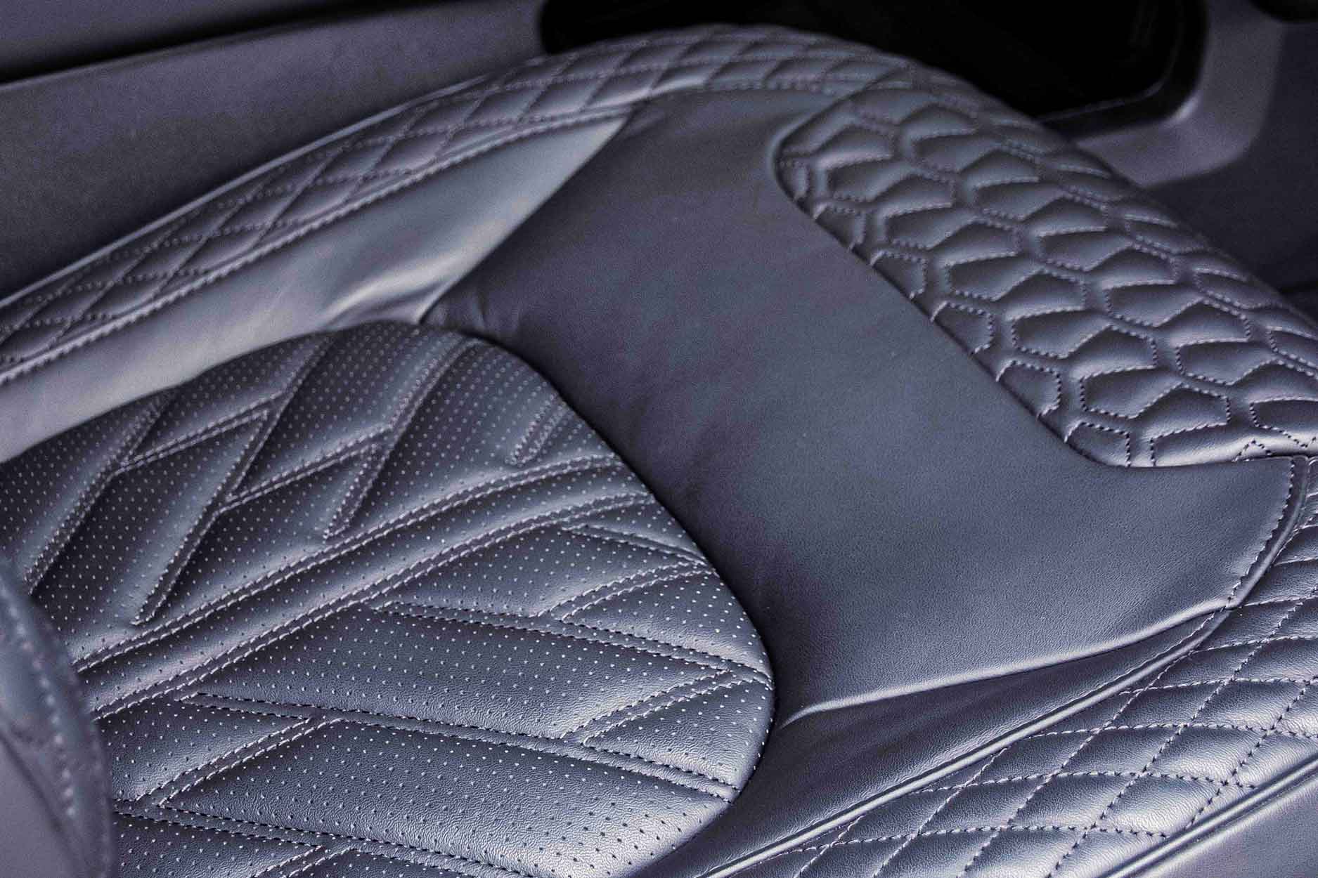 Quilted black leather car seat with diamond pattern, Barugzai Falcon Xpression Interior in a Land Rover Defender 110 L663