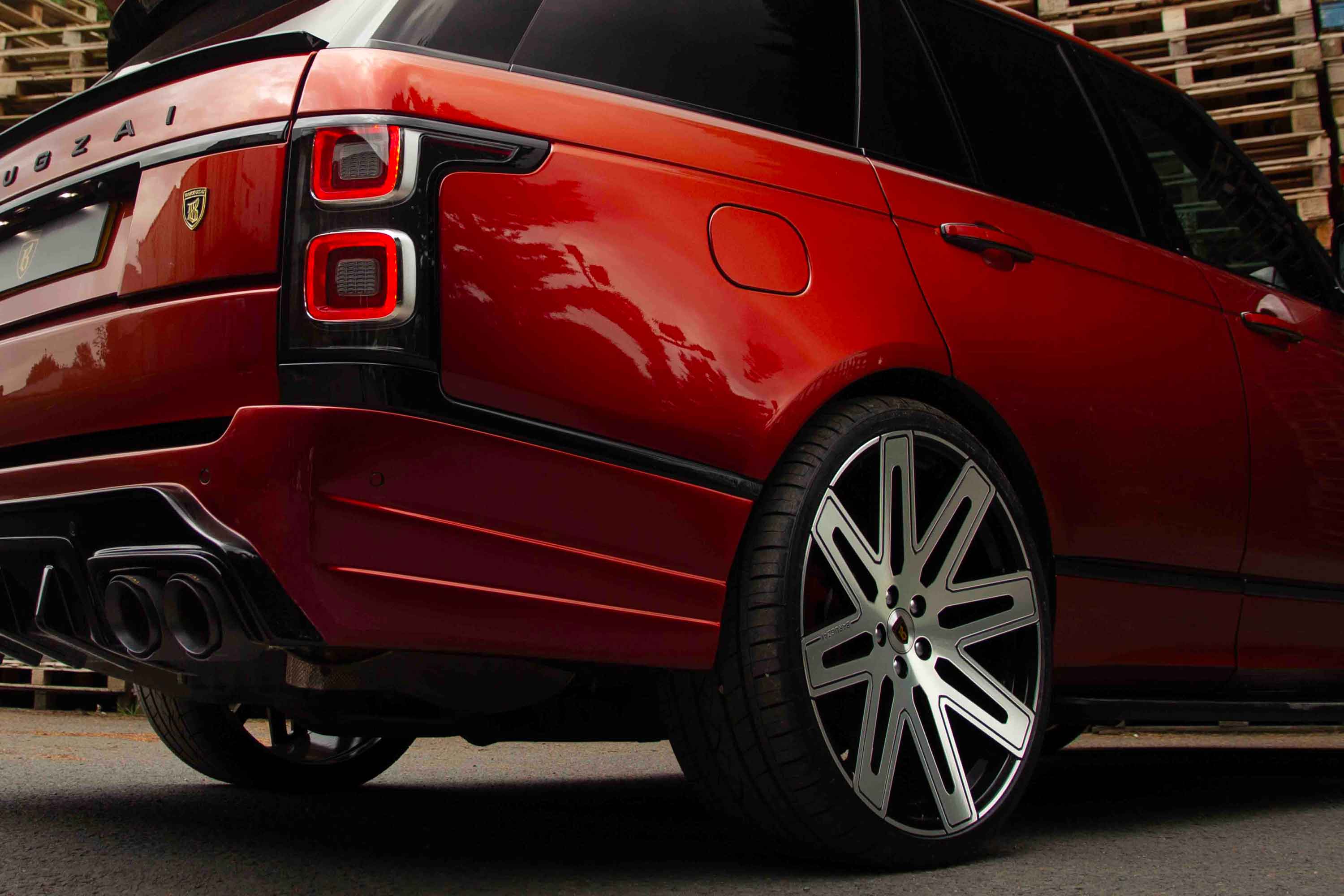 Red Range Rover L405, fitted with Barugzai Bison bodykit with visible branding on a blurred background. Fitted with EXEL 24