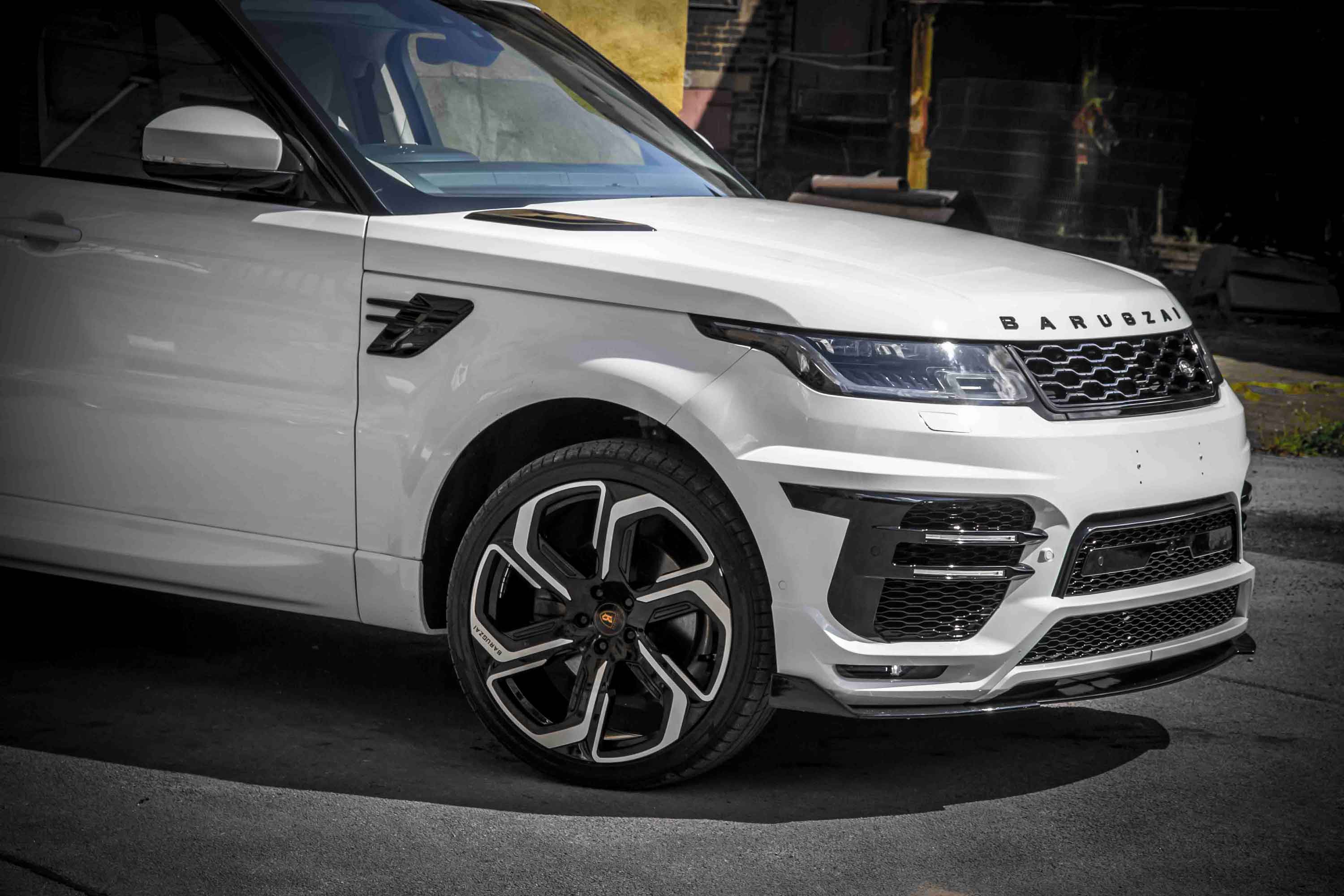 White Range Rover Sport L494, fitted with Barugzai Sport Aero II with a black a dark tarmac background