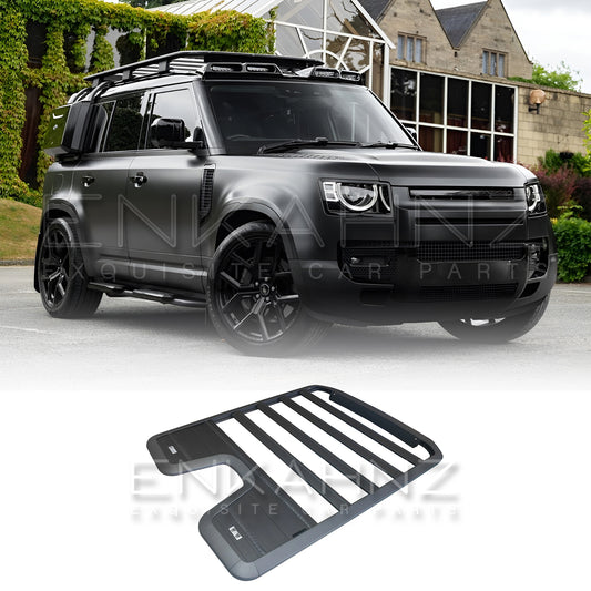 Black Defender with roof rack system in front of a building