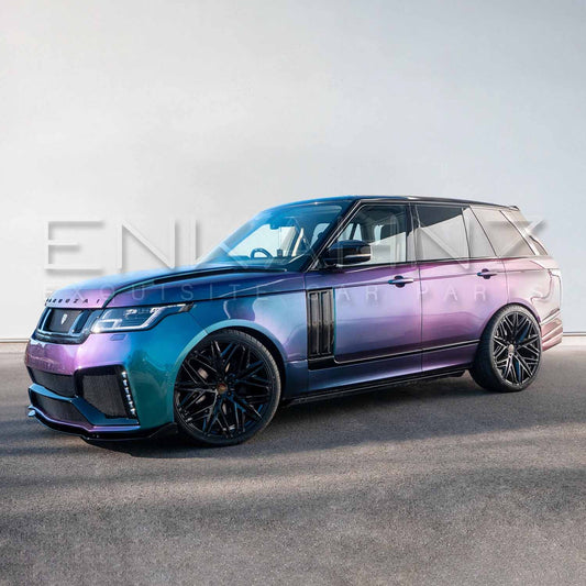 Front quarter angle toward the side of turquoise Range Rover Vogue with Barugzai Bison kit, showcasing arches and side skirts.