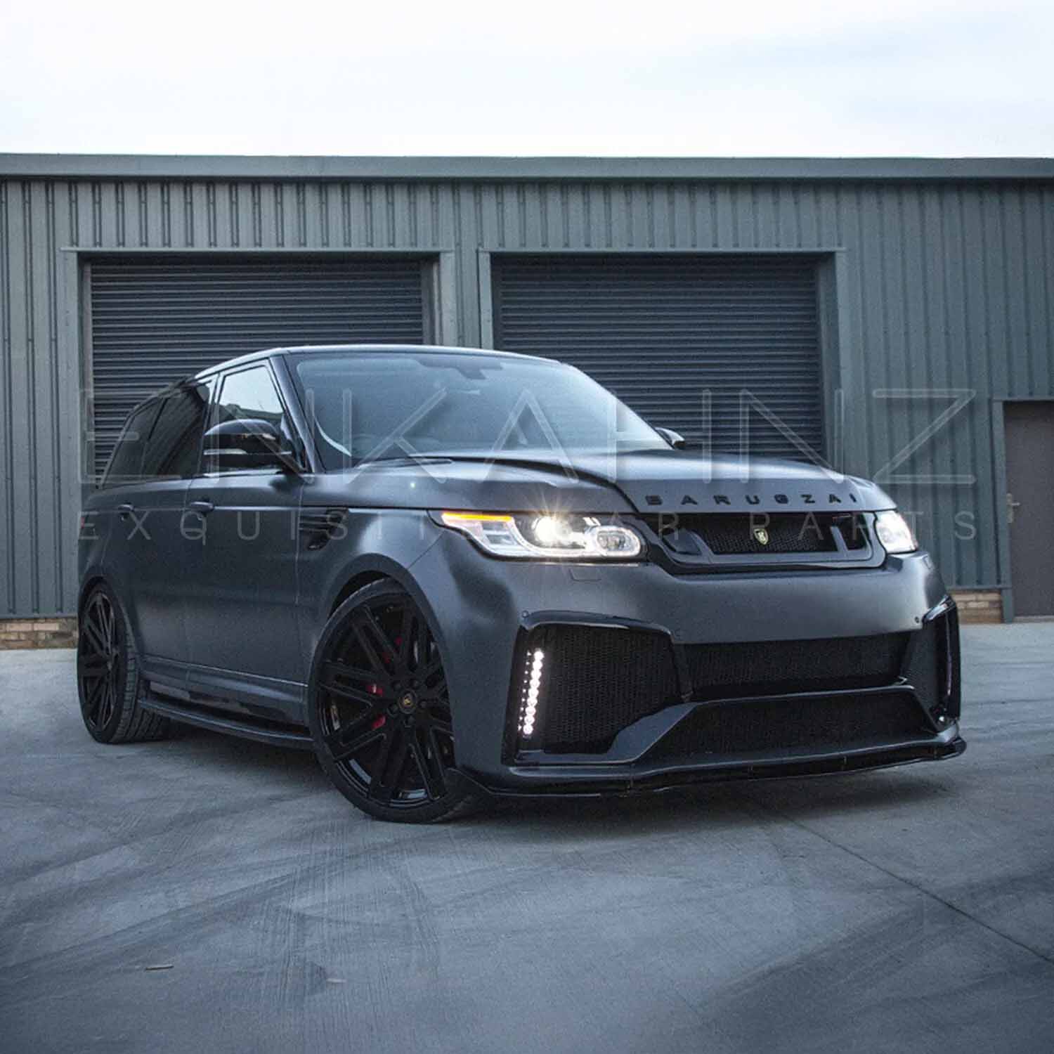 Front quarter lower angle of matte grey Range Rover Sport with Cabaro kit for aggressive road presence.