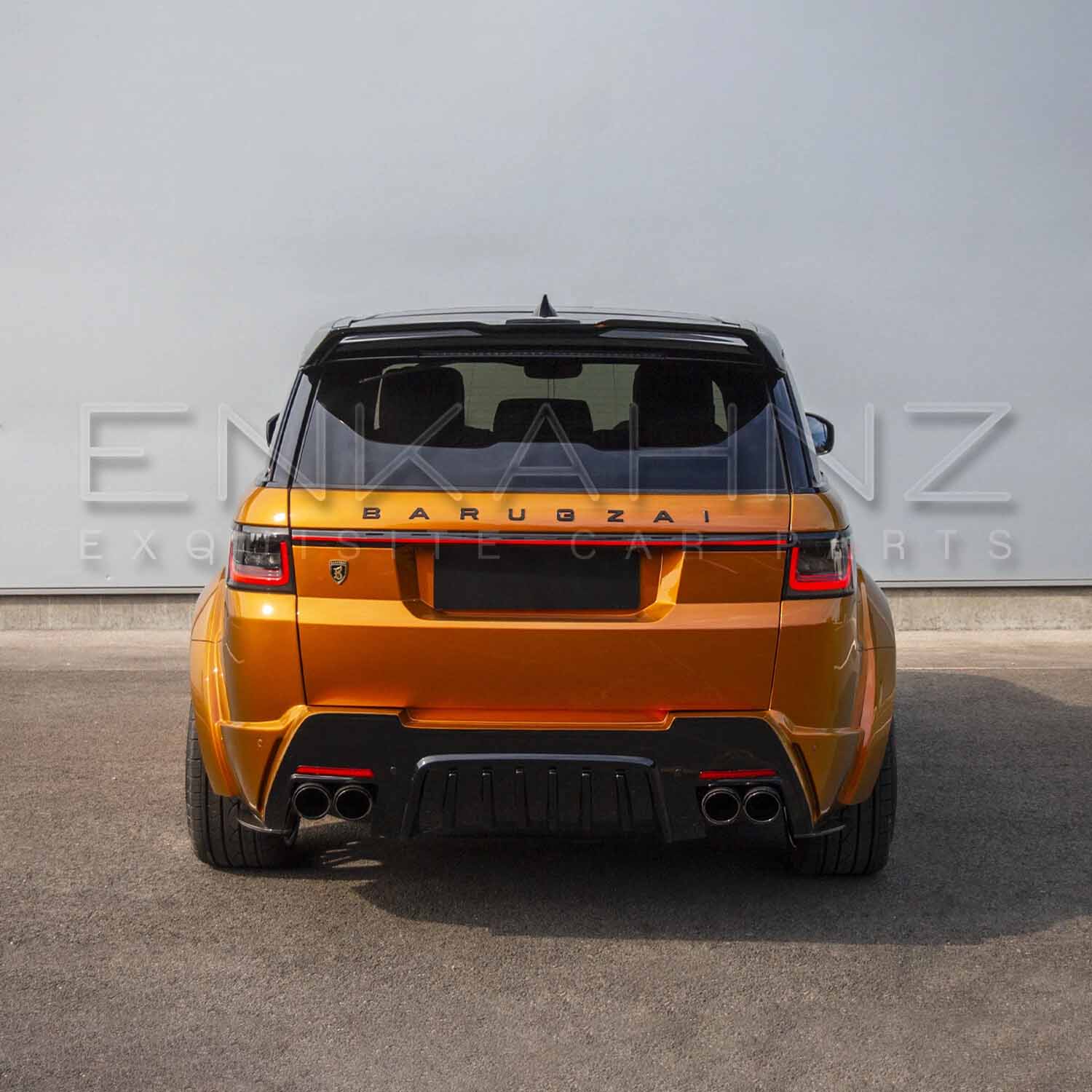 Rear angle of orange Range Rover Sport Cabaro Wide Arch, showcasing diffuser, bumper, exhaust surrounds and roof spoiler.