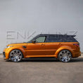 Load image into Gallery viewer, Side angle of orange Range Rover Sport with Cabaro Wide Arch kit, emphasizing flared arches, side skirts and wheel fitment.
