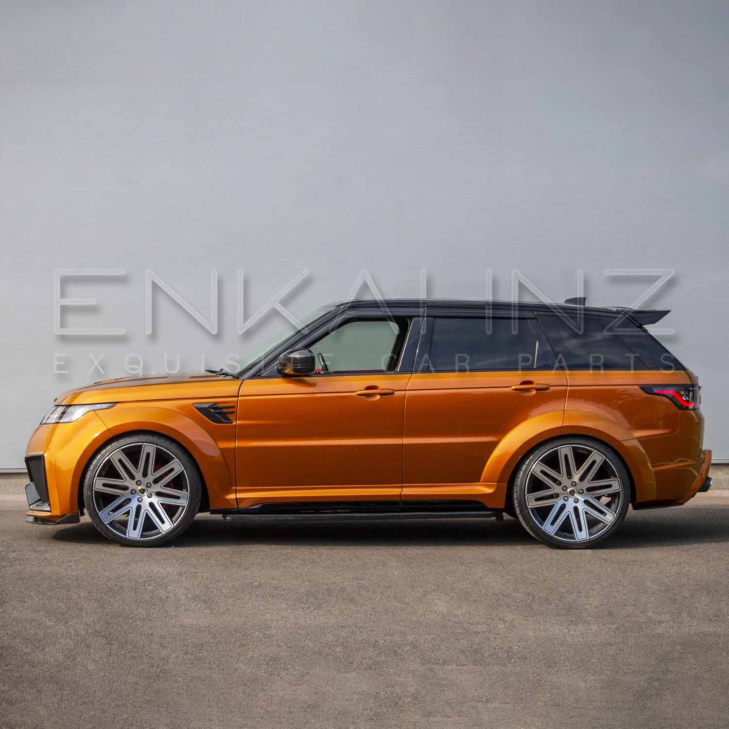 Side angle of orange Range Rover Sport with Cabaro Wide Arch kit, emphasizing flared arches, side skirts and wheel fitment.