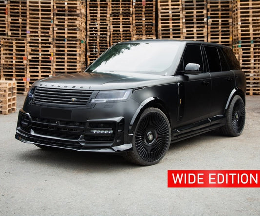 Range Rover Vogue L460 2023+ in  black with Barugzai Nebula bodykit and Vortex wheels, front quarter angle with stacked wooden crates in the background.