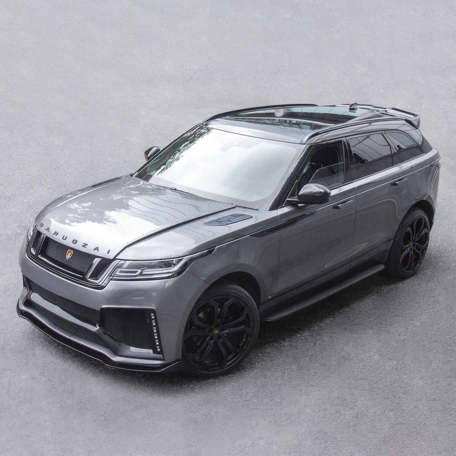 Top front quarter angle of Velar Huntress on road backdrop, highlighting grille, apron and Casanova wheel stance.