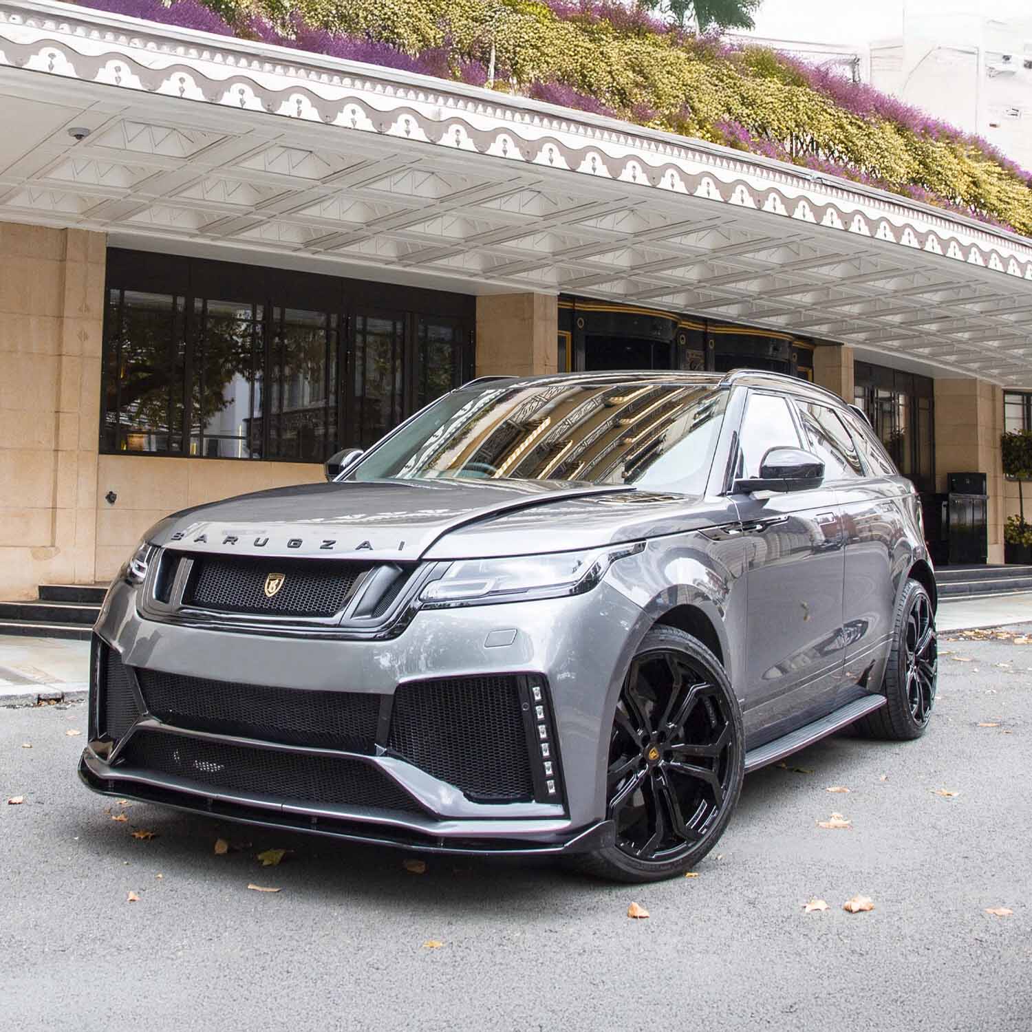 Front slightly lower quarter angle at five‑star hotel entrance, focusing on apron details and aggressive stance.