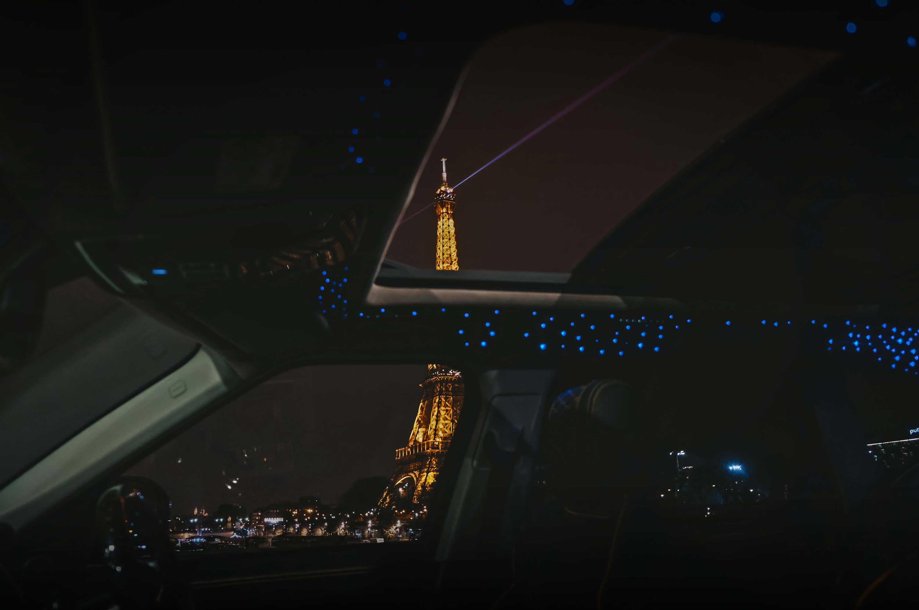 View of the Eiffel Tower from inside a Range Rover Sport L494 at night. Shot from Barugzai Cabaro II, fitted with the Galaxy Roof Lining