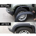 Load image into Gallery viewer, Comparison image showing before and after fitting ENKAHNZ matte black wheel arches on a blue Defender 110, illustrating the transformation to a wider, more muscular stance with Shuracan gloss black wheels.
