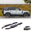 Load image into Gallery viewer, White Defender 110 with black roof rack and side steps on a grassy field background with side step product at the bottom
