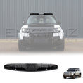 Load image into Gallery viewer, Front view of a white Defender fitted with a 4 LED front light bar mounted above the windshield.
