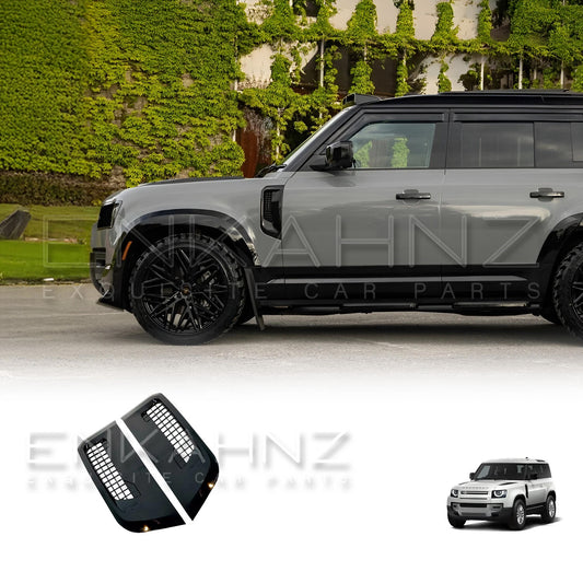 Enkahnz Side vents gloss black fitted on the Grey Defender 110 with Shuracan Wheels on them facing side ways in front of a beautiful mansion with side vents product displayed at the bottom