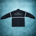 Load image into Gallery viewer, Enkahnz Signature Crowan Jacket – Black in a teal background. 
