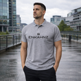 Load image into Gallery viewer, Enkahnz Trademark Polo T-Shirt – Grey in a natural road setting.
