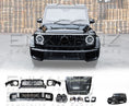 Load image into Gallery viewer, Rear View of a Black Mercedes-Benz G Wagon with Enkahnz W463 2008-17 TO W465 G63 2025 Bodykit highlighted with an opaque white background. The items of the body kit are the Front Bumper, Rear Bumper, Centre Grille, Wheel Arches (x4), Headlight Covers (x2), Bonnet, Rear lights cover (x2), Mirrors (x2), Front Headlamps (x2), Front Wings (x2), Door Strips and 'Enkahnz' branding with a background of a warehouse. The parts are depicted in the bottom with a white background. 

