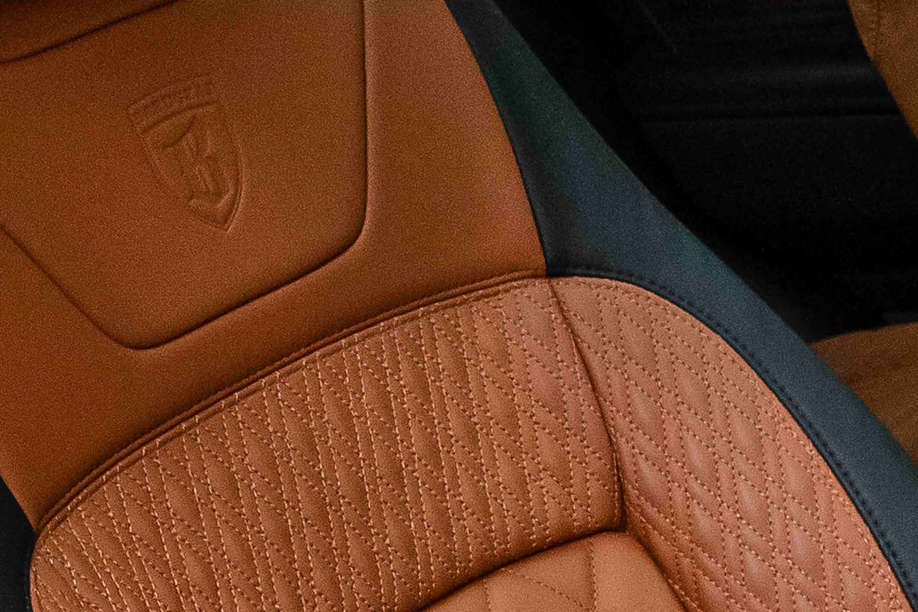 Close-up of a Barugzai car seat with brown leather and stitching detail in a  Range Rover L405