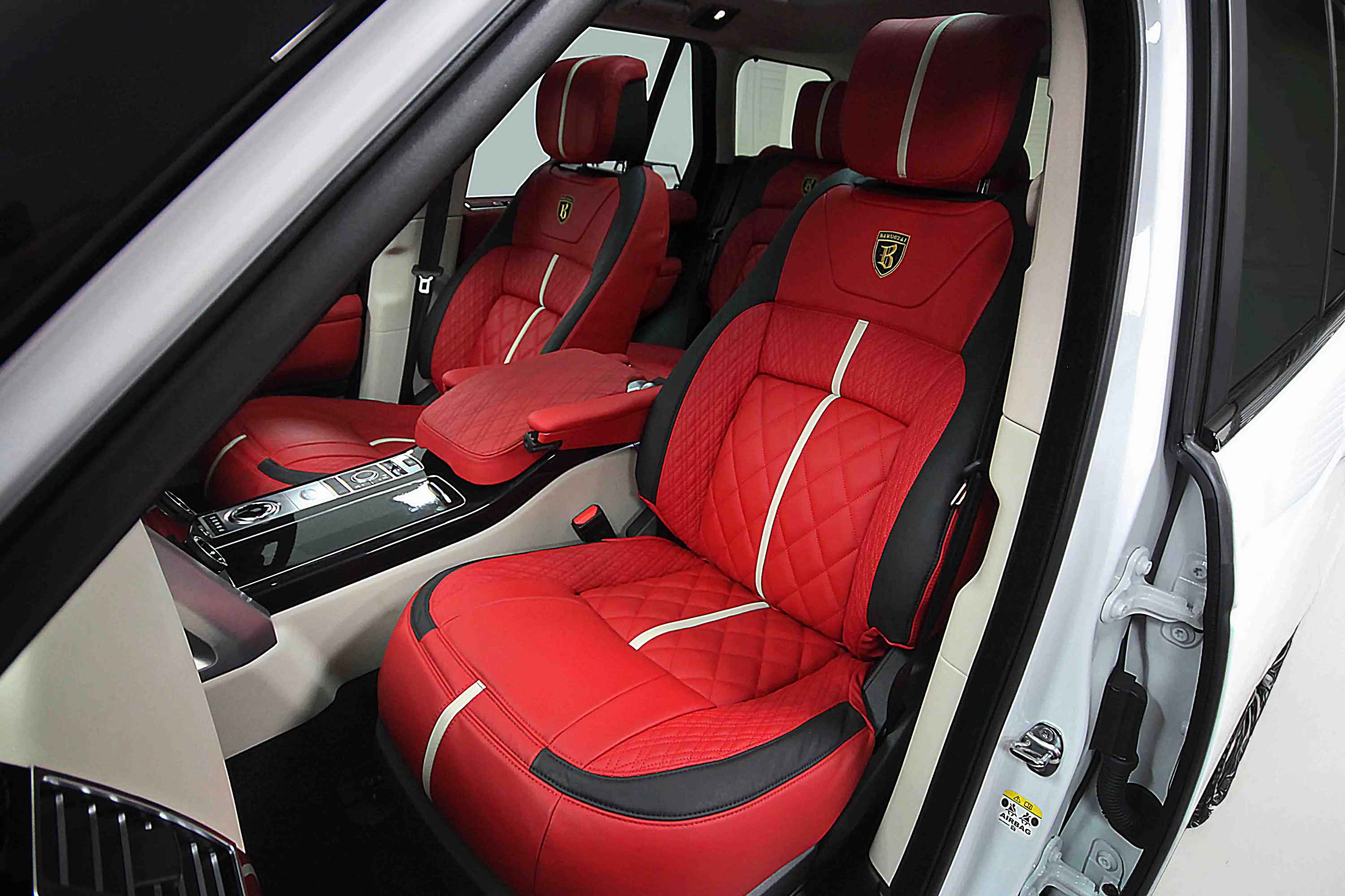 Red interior seats with black accents and cream racing stripe inside a Range Rover L405
