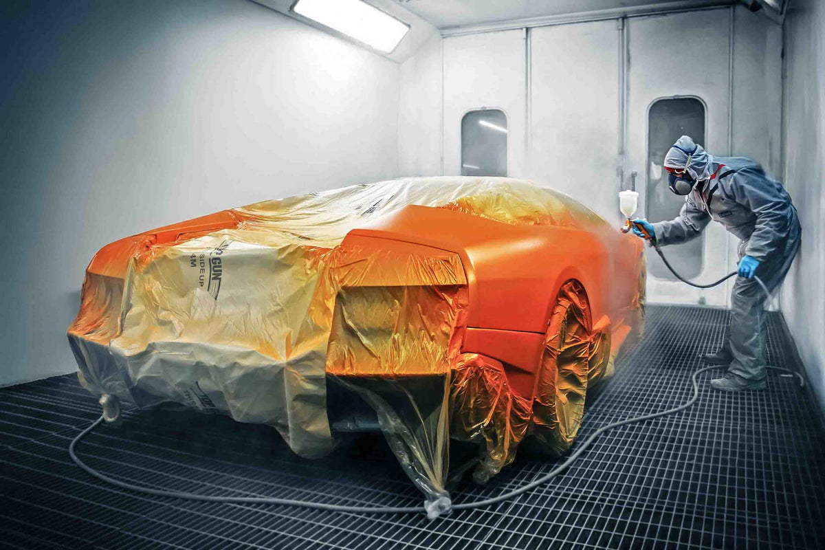 Lamborghini Gallardo being painted Orange in the Enkahnz spray booth with protective covering