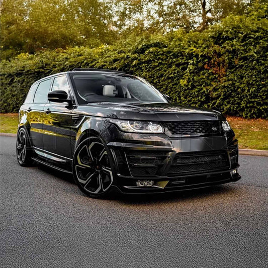 Jet black Range Rover Sport (2013-2017) fitted with ENKAHNZ LM Style bodykit, viewed from the front quarter in a park with autumn foliage and a sunset backdrop, highlighting the bold new look.