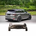 Load image into Gallery viewer, Rear quarter view of a golden-silver Range Rover Sport 2018–2022 parked outdoors, fitted with the Enkahnz aftermarket LM style rear bumper, with a product image of the bumper at the bottom.

