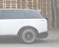 Load image into Gallery viewer, Close Up Side View of a Gloss Black and White Range Rover Vogue L460 2022+ Mid Boot Spoiler in a warehouse setting with Enkahnz Branding.
