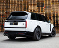 Load image into Gallery viewer, Rear Quarter View of a Gloss Black and White Range Rover Vogue L460 2022+ in a warehouse setting with Enkahnz Branding.
