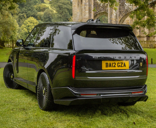 Quarter Rear View of a Gloss Black Range Rover Vogue L460 2022+ on the grass with Barugzai Branding.