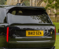 Load image into Gallery viewer, Quarter Rear View of a Close up of the Black Range Rover and the spoiler in Barugzai Branding. 
