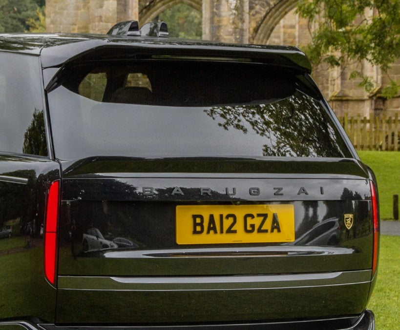 Quarter Rear View of a Close up of the Black Range Rover and the spoiler in Barugzai Branding. 