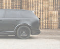 Load image into Gallery viewer, Side View of a Gloss Black Range Rover Vogue 2022+ L460 Mid Boot Spoiler in a warehouse setting with Enkahnz Branding.
