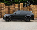 Load image into Gallery viewer, Side View of a Gloss Black Range Rover Vogue 2022+ L460 in a warehouse setting with Enkahnz.
