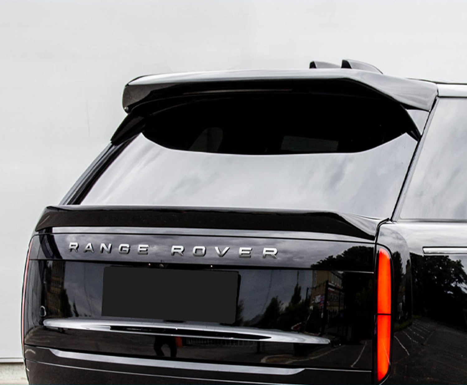 Close up of a Black Range Rover Vogue L460 2022+ with a grey background. 