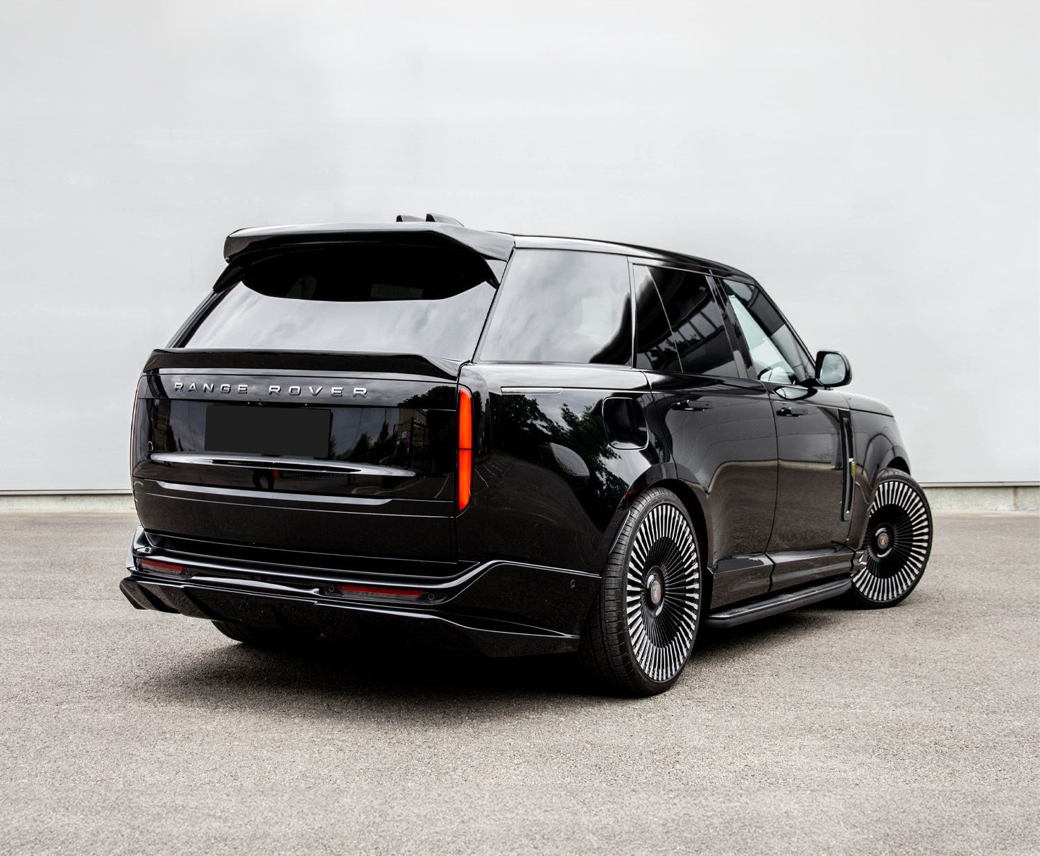 Rear Quarter View of a Black Range Range Rover Vogue 2022+ on a grey background with a Barugzai Roof Spoiler.