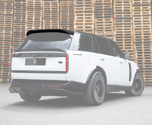 White Range Rover with a roof spoiler in focus with a white background front of stacked wooden pallets with Enkahnz Bradford.