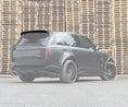 Load image into Gallery viewer, Rear Quarter View of the Range Rover Vogue L460 2022+ Gloss Black Roof Spoiler depicted on a white opaque background of the car in a warehouse setting.
