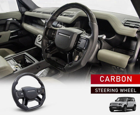 STEERING WHEEL CARBON FIBRE FOR LAND ROVER DEFENDER STYLE 90/110/130 (2020+) in a side angle with the interiors and the product in the bottom with a white background. 