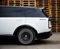 Load image into Gallery viewer, White Range Rover Vogue 2022+ closeup with a Roof Spoiler in front of wooden pallets, featuring Enkahnz branding.

