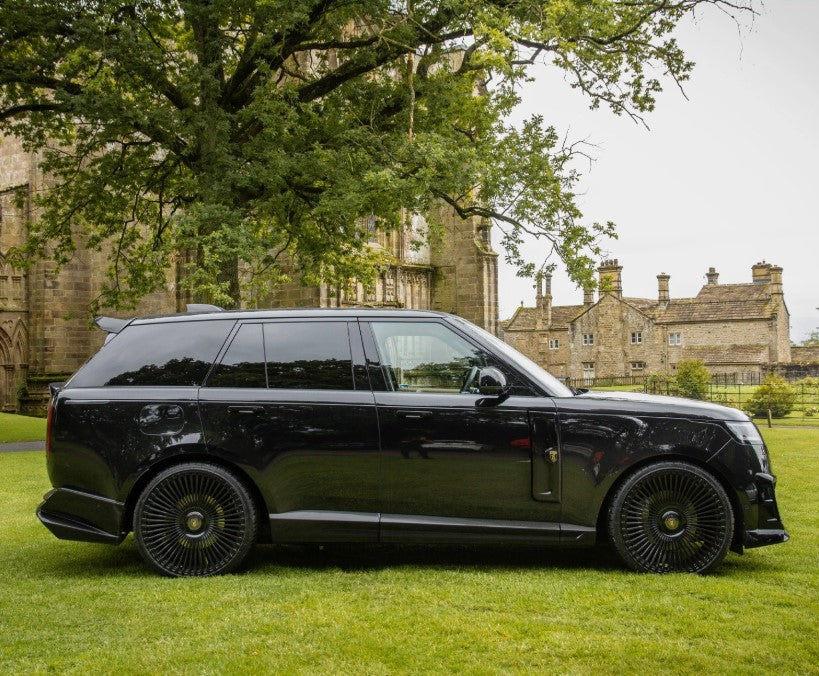 Side View of the Black Range Rover Vogue L460 2022+ on the green grass with Barugzai Branding. 