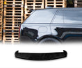 Load image into Gallery viewer, Side view of a Range Rover L460 Vogue Gloss Black with a Rear Roof Spoiler with wooden pallets in the background and the rear roof spoiler placed in front of a white background in the bottom.
