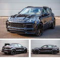 Load image into Gallery viewer, Dark Blue Porsche Cayenne 2019, fitted with Barugzai Eleganza II bodykit, shown from different angles parked on a road with a grey background. Fitted with Barugzai EXEL 24" alloy wheels in Gloss Black
