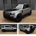 Load image into Gallery viewer, Silver Land Rover Defender 110 L663 2020, parked outside a warehouse. Fitted with Barugzai Shuracan 22" alloy wheels in Gloss Black 
