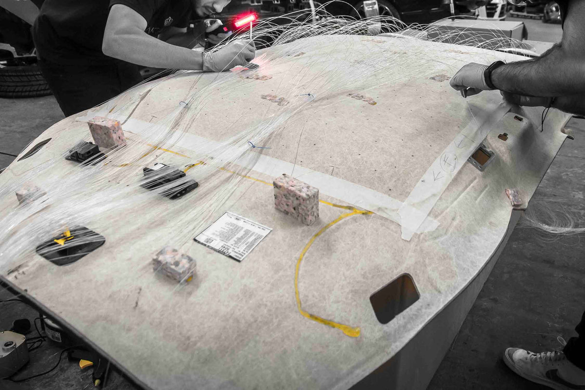 Close-up of the reverse side of a roof lining removed from a Range Rover Sport L494. Fitting fibre optics to create the "starry sky" effect. In Enkahnz workshop 